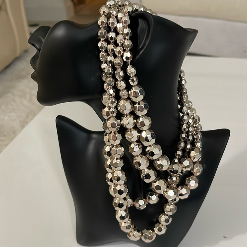 Beaded necklace… Silver beads… Four strands of beads